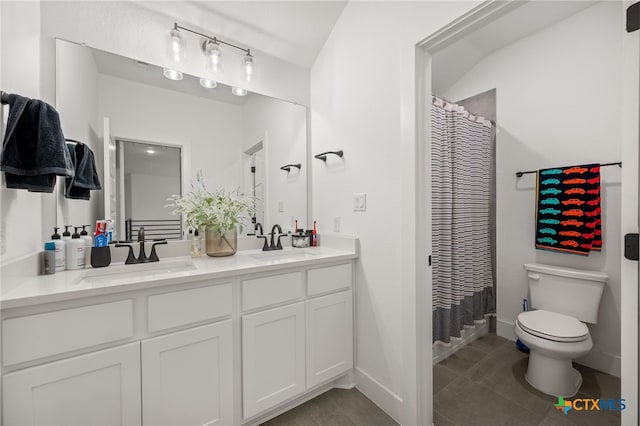 bathroom with a shower with curtain, vanity, toilet, and tile patterned floors