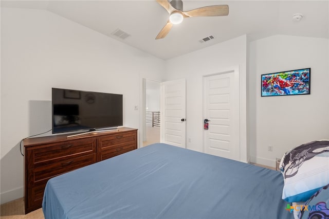 bedroom with light carpet, a closet, vaulted ceiling, and ceiling fan