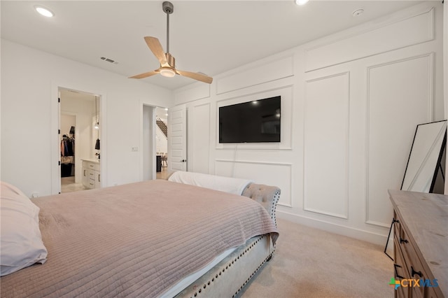 carpeted bedroom featuring ceiling fan and connected bathroom