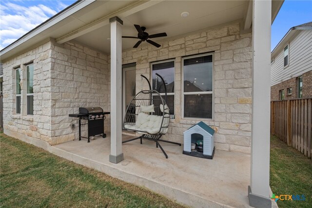 view of patio / terrace with ceiling fan and a grill