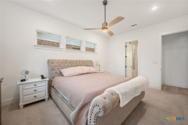 carpeted bedroom featuring ensuite bathroom and ceiling fan