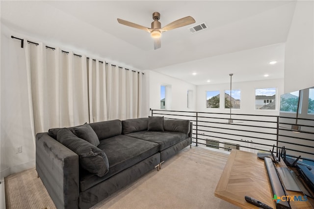 living room featuring ceiling fan and light colored carpet