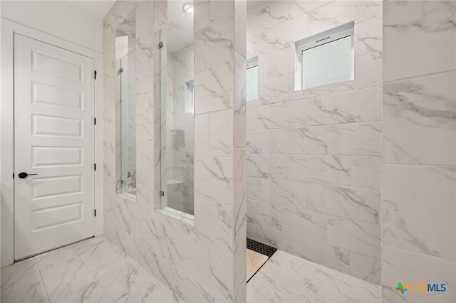 bathroom with a tile shower