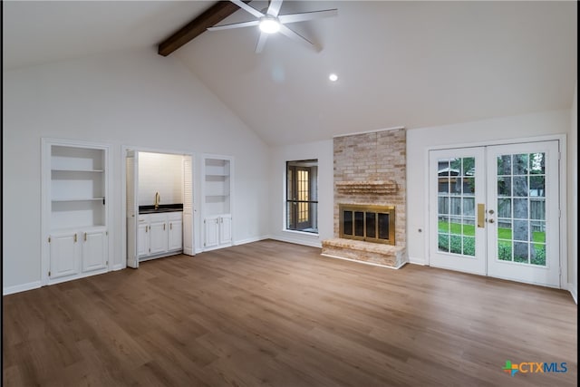 9215 Standing Creek Ln, San Antonio, TX 78230 - unfurnished living room with ceiling fan, beamed ceiling, french doors, high vaulted ceiling, and healthy amount of natural light