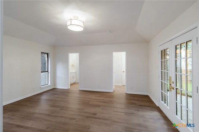 9215 Standing Creek Ln, San Antonio, TX 78230 - spare room featuring french doors, vaulted ceiling, wood finished floors, and baseboards