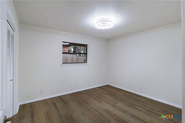 9215 Standing Creek Ln, San Antonio, TX 78230 - unfurnished bedroom featuring dark wood finished floors, baseboards, and a closet