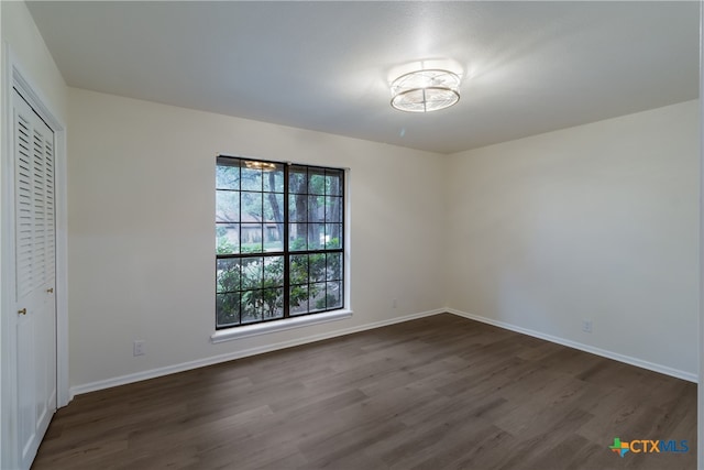 9215 Standing Creek Ln, San Antonio, TX 78230 - unfurnished bedroom featuring dark wood-style flooring, baseboards, and a closet