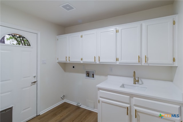 9215 Standing Creek Ln, San Antonio, TX 78230 - laundry room with electric dryer hookup, cabinet space, washer hookup, wood finished floors, and hookup for a gas dryer