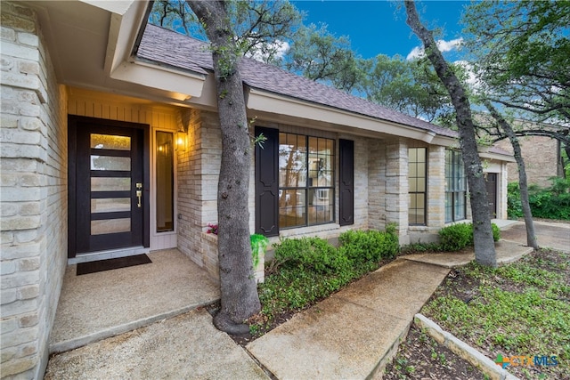 9215 Standing Creek Ln, San Antonio, TX 78230 - entrance to property with a shingled roof, stone siding, and brick siding