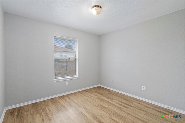 spare room featuring light hardwood / wood-style floors