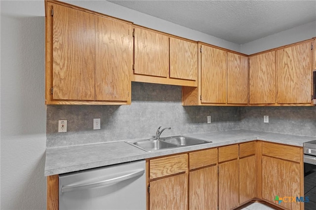 kitchen with tasteful backsplash, a textured ceiling, stainless steel appliances, sink, and tile patterned flooring