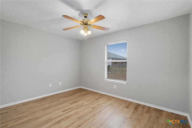 empty room with light wood-type flooring and ceiling fan