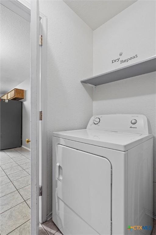 laundry area with light tile patterned floors and washer / clothes dryer