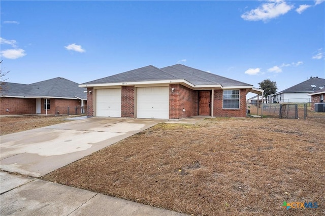 view of front of house featuring central AC unit and a garage