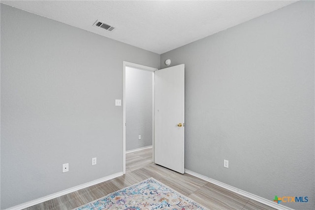 unfurnished room featuring light hardwood / wood-style flooring