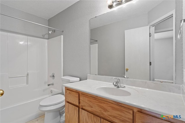 full bathroom featuring vanity, toilet, a textured ceiling, and bathing tub / shower combination