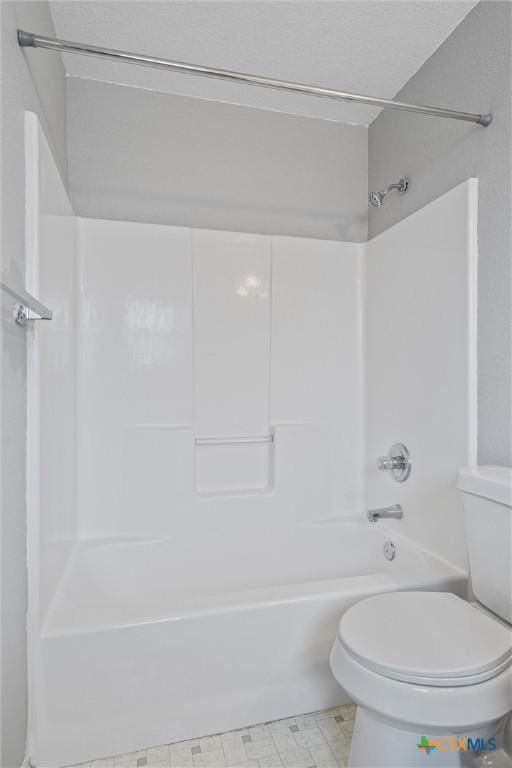 bathroom featuring shower / bath combination and toilet