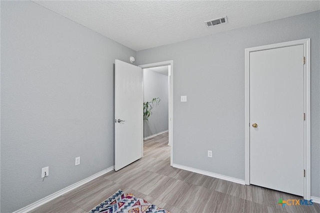 unfurnished bedroom with a textured ceiling