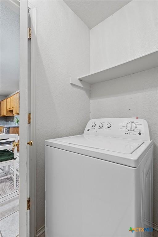 clothes washing area with washer / dryer