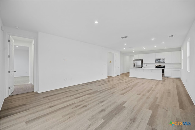 unfurnished living room with light hardwood / wood-style flooring