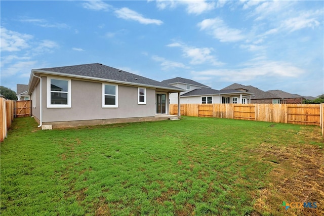 rear view of house with a yard