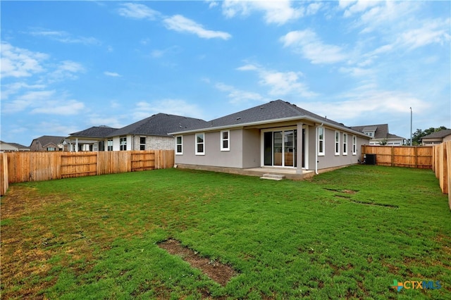 back of house with a lawn