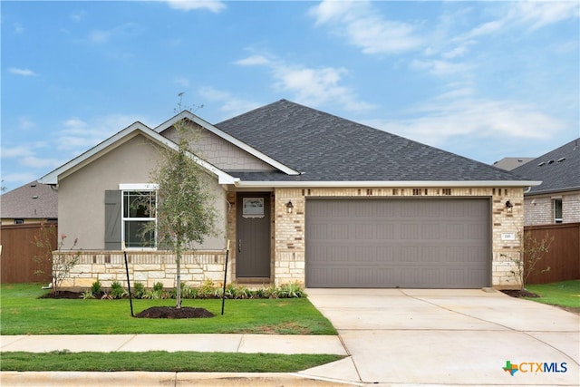 view of front of property featuring a front lawn and a garage