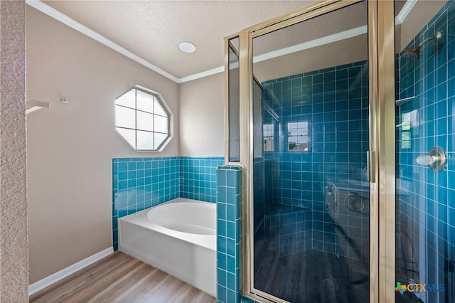 full bathroom with a shower stall, ornamental molding, wood finished floors, and a garden tub