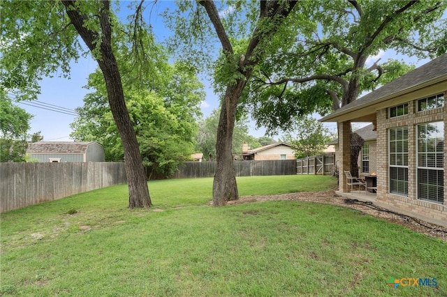 view of yard with a fenced backyard