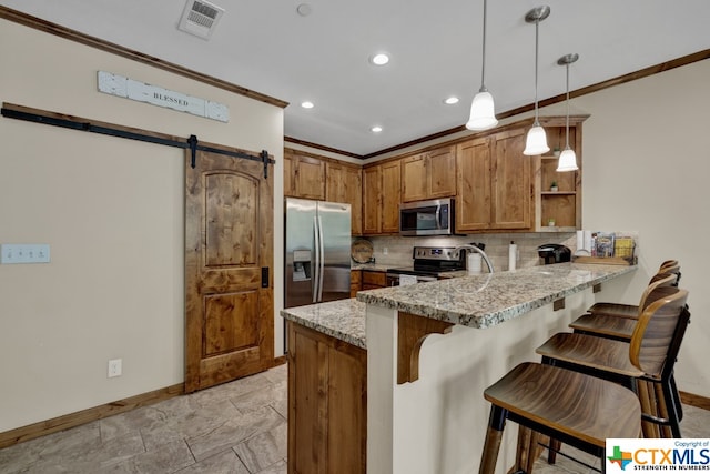 kitchen featuring light stone counters, backsplash, appliances with stainless steel finishes, hanging light fixtures, and kitchen peninsula