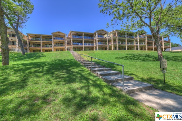 view of property's community with a yard