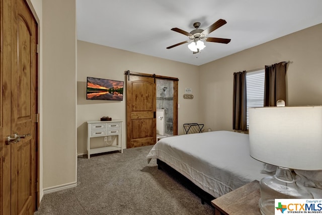 bedroom featuring a barn door, ceiling fan, ensuite bath, and carpet floors