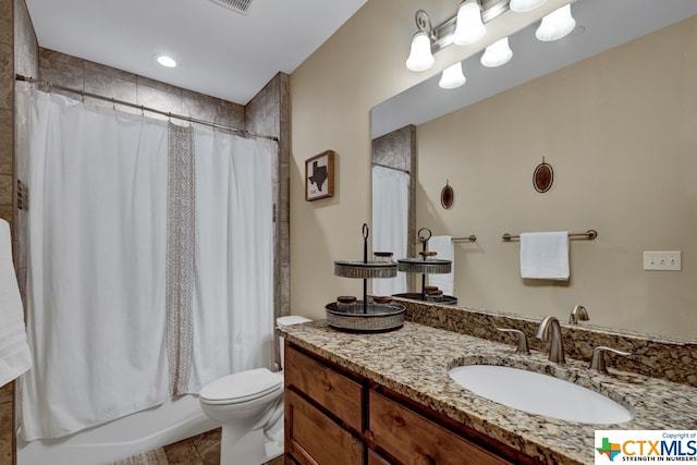 full bathroom with toilet, tile patterned floors, vanity, and shower / bath combo with shower curtain