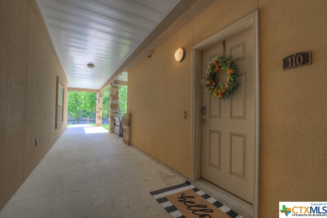 doorway to property featuring covered porch