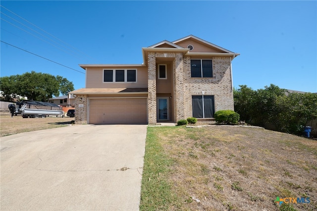 view of property with a garage and a front yard