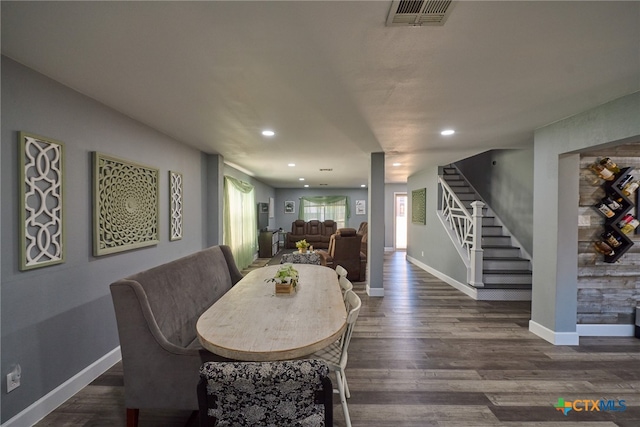 dining space featuring dark wood-type flooring