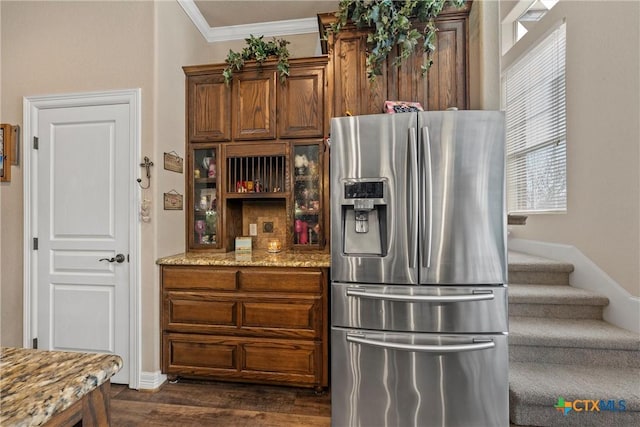 924 Queen Elizabeth Dr, Mcgregor, TX 76657 - kitchen featuring light stone counters, dark wood-style floors, stainless steel fridge, and ornamental molding