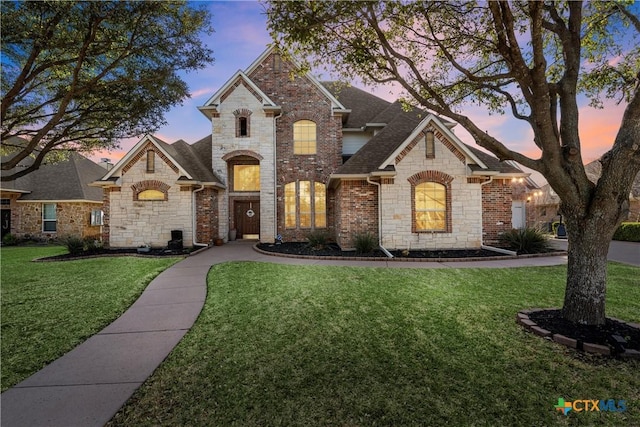 924 Queen Elizabeth Dr, Mcgregor, TX 76657 - french country home with stone siding, a lawn, and a shingled roof
