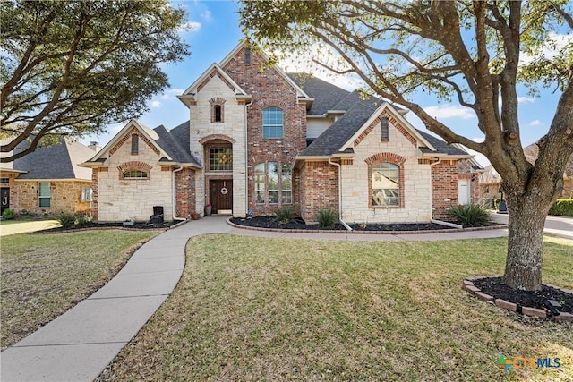 924 Queen Elizabeth Dr, Mcgregor, TX 76657 - french country home featuring a front yard, brick siding, stone siding, and roof with shingles