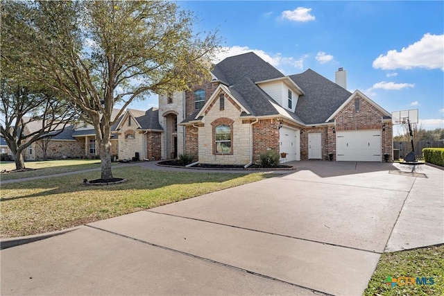 924 Queen Elizabeth Dr, Mcgregor, TX 76657 - french country inspired facade with a front yard, driveway, roof with shingles, a garage, and brick siding