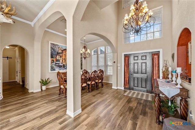 924 Queen Elizabeth Dr, Mcgregor, TX 76657 - entrance foyer with baseboards, an inviting chandelier, wood finished floors, and ornamental molding