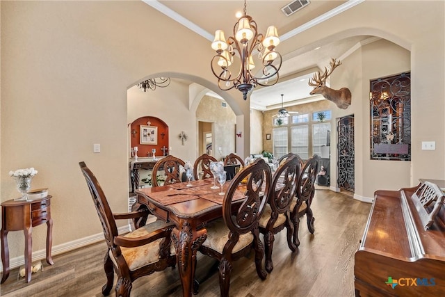 924 Queen Elizabeth Dr, Mcgregor, TX 76657 - dining room with arched walkways, visible vents, crown molding, and wood finished floors