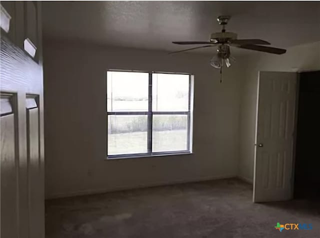 unfurnished room with carpet flooring and ceiling fan