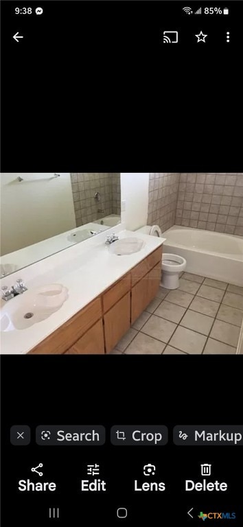 bathroom featuring vanity, a tub, and tile patterned flooring