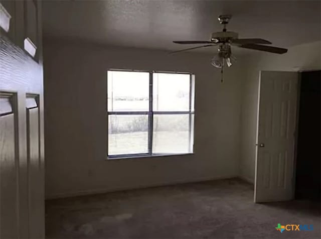 unfurnished room with carpet floors and ceiling fan