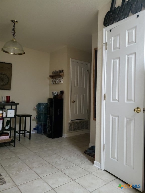 corridor with light tile patterned floors