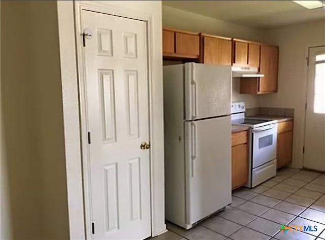 kitchen featuring white appliances and light tile patterned floors