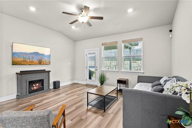 355 Victoria Peak Loop, Dripping Springs, TX 78620 - living room featuring healthy amount of natural light, ceiling fan, wood finished floors, a stone fireplace, and lofted ceiling