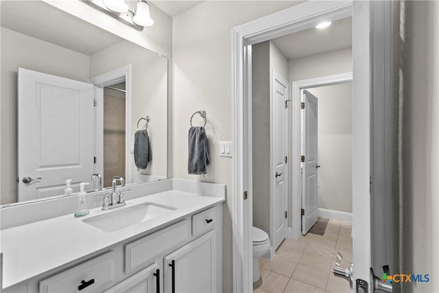 355 Victoria Peak Loop, Dripping Springs, TX 78620 - bathroom with toilet, vanity, and baseboards