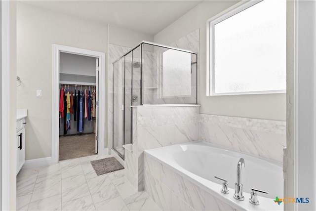355 Victoria Peak Loop, Dripping Springs, TX 78620 - full bath with a stall shower, a garden tub, vanity, and a walk in closet